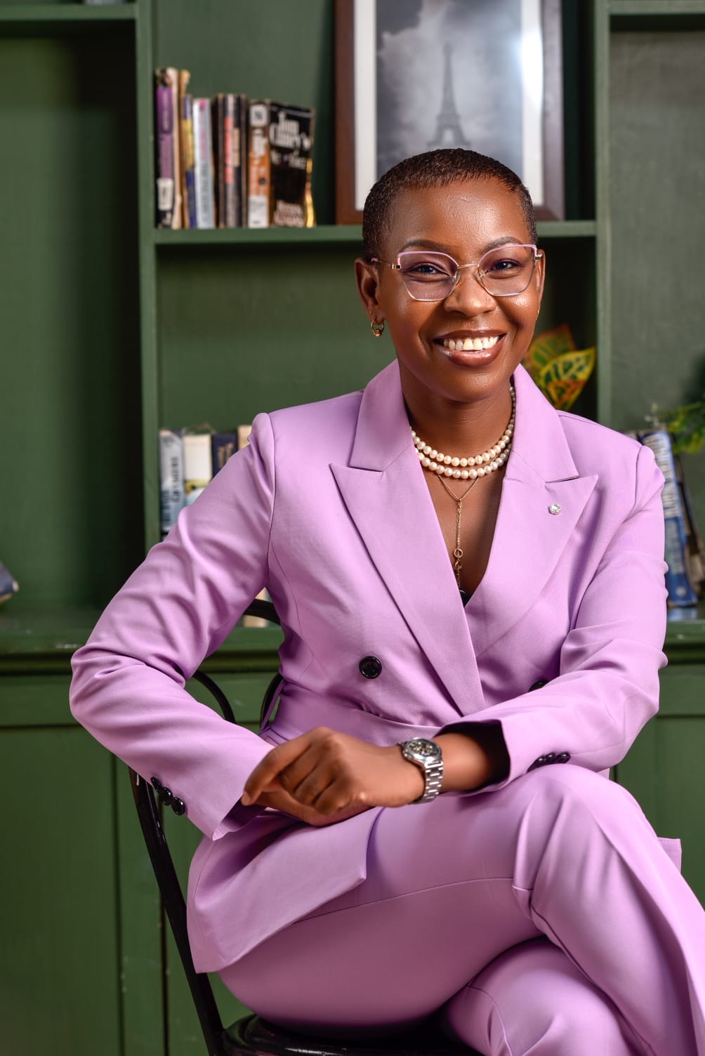 Eunice Ireri — Emerald suit — hands clasped