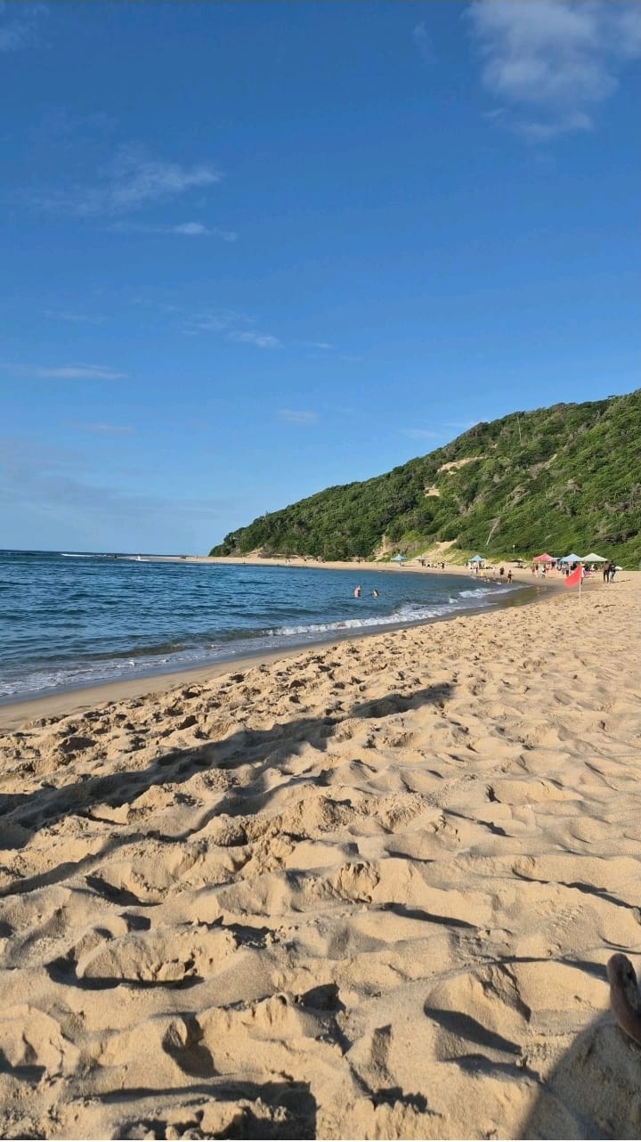 The golden sand and turquoise water of Ponta do Ouro beach in Mozambique