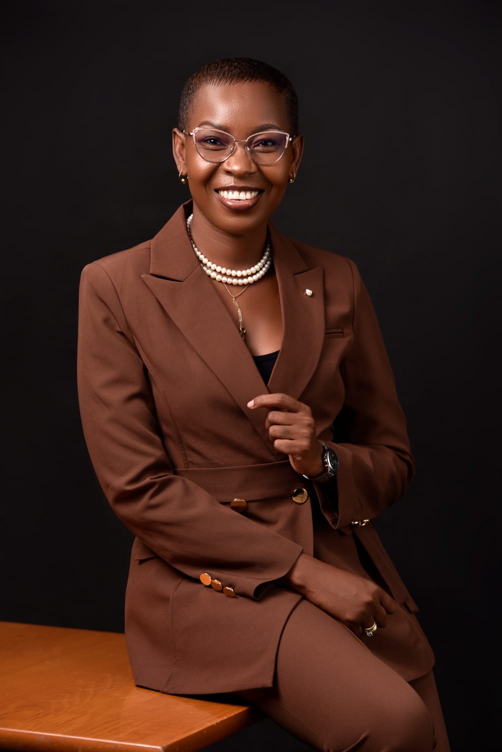 Eunice Ireri — Navy suit — arms crossed