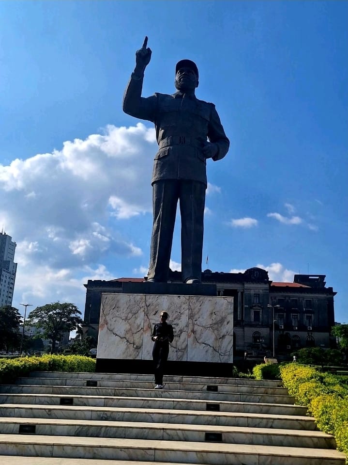 The statue of Samora Machel at Praça da Independência in Maputo, with Eunice standing at its base