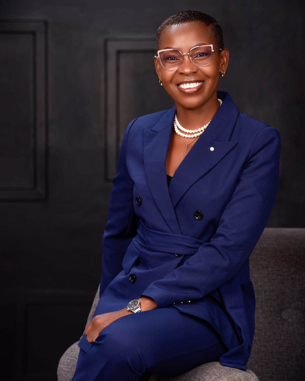 Eunice Ireri — Navy suit — seated portrait